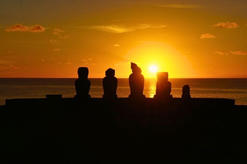 sunset behind the statues of Easter Island