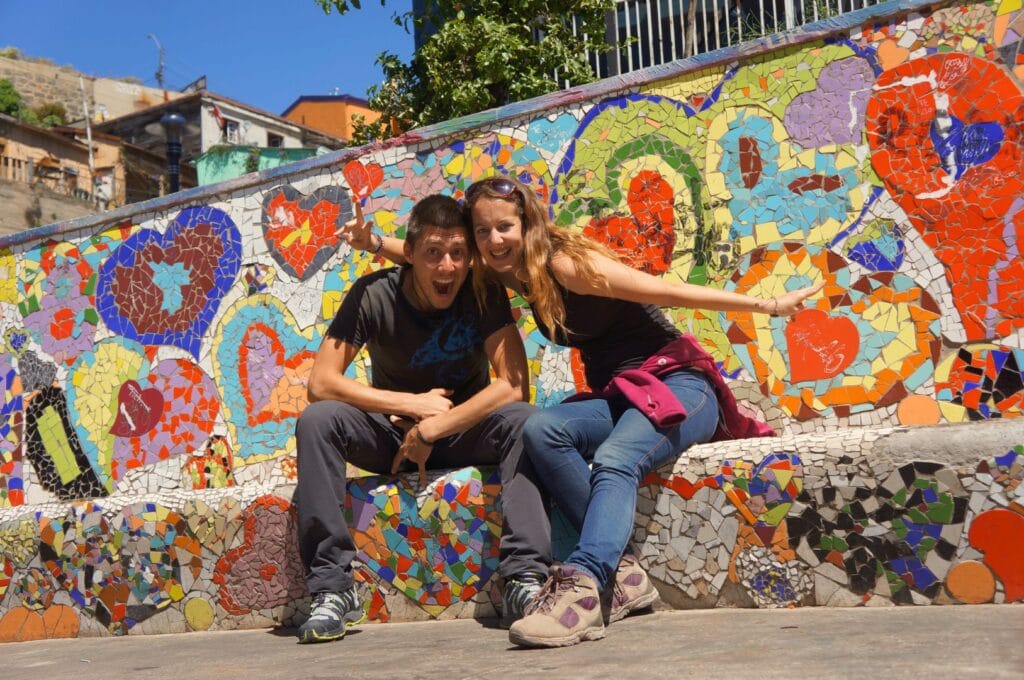 Fabienne and Benoit in front of street art